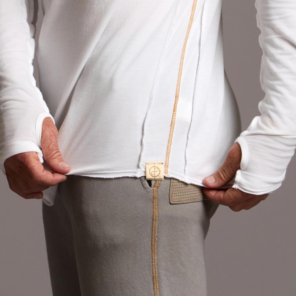 Man modeling white long-sleeve hooded tee