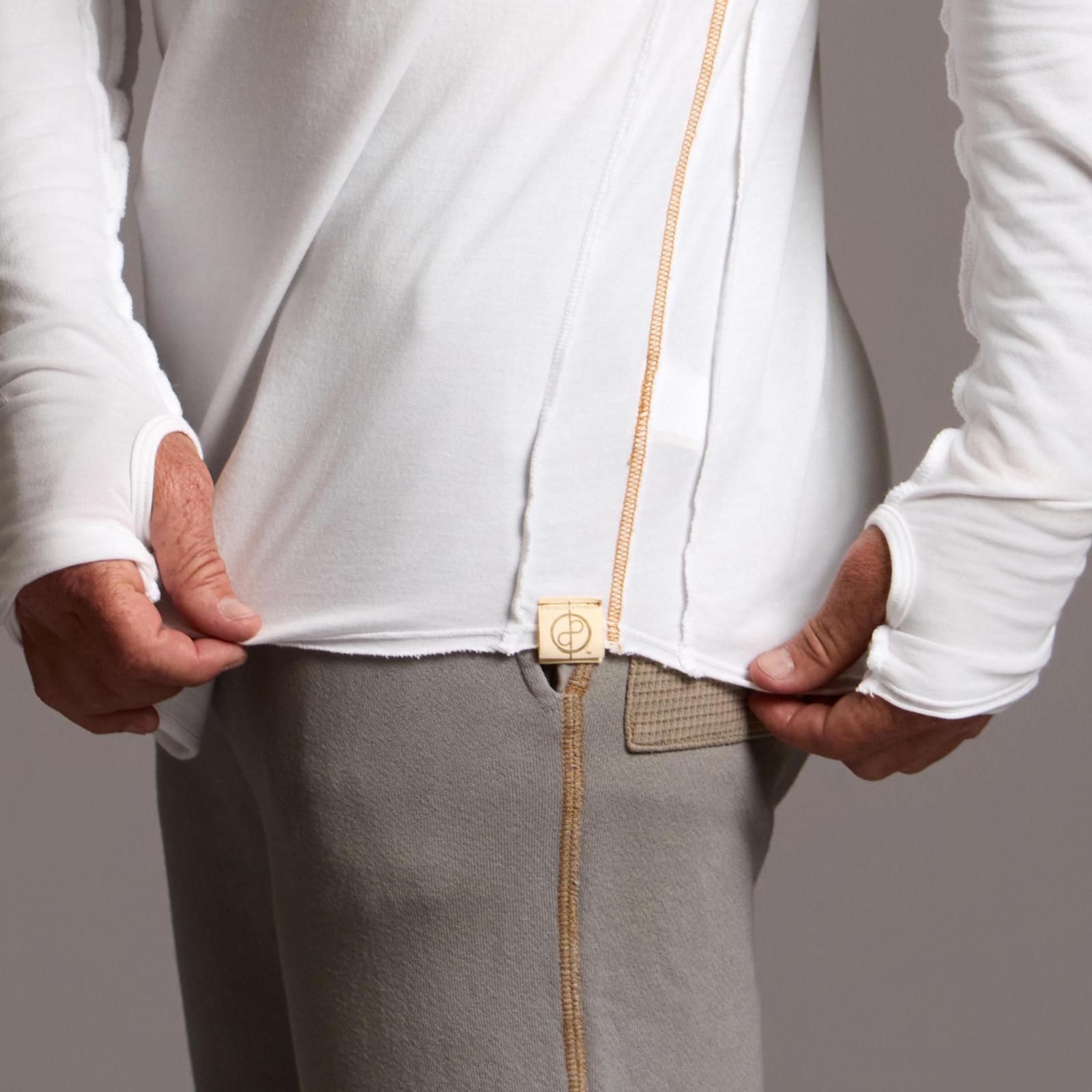 Man modeling white long-sleeve hooded tee