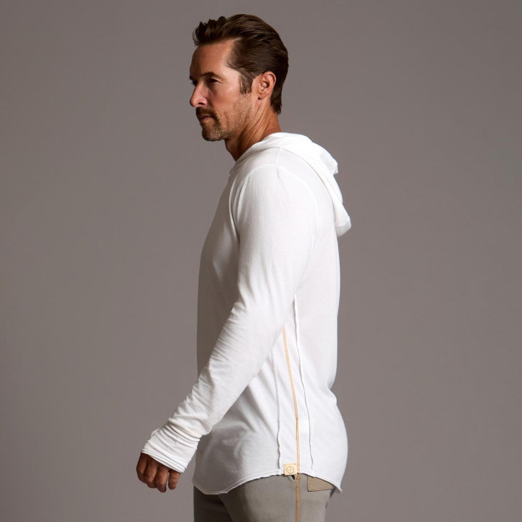 Man modeling white long-sleeve hooded tee