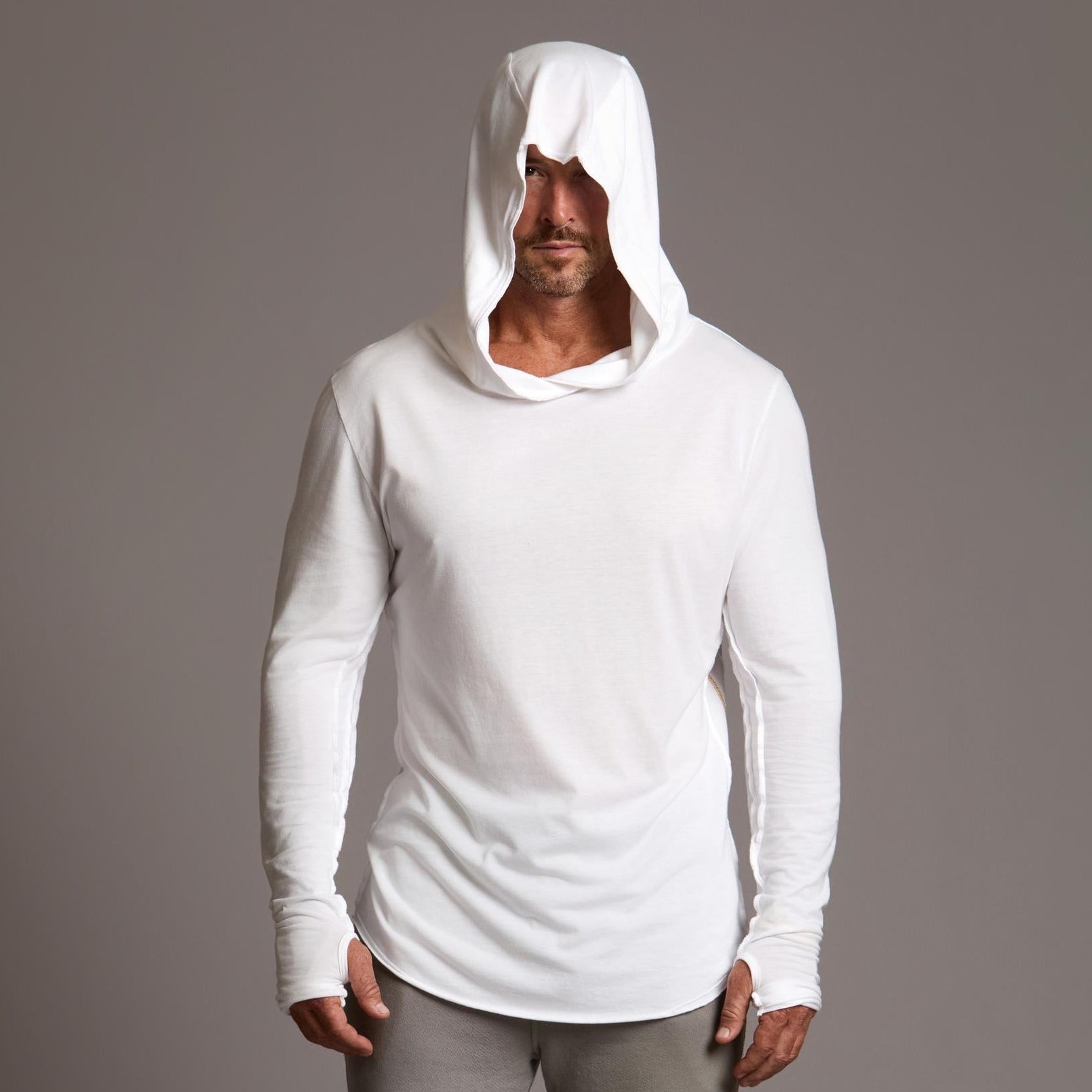 Man modeling white long-sleeve hooded tee
