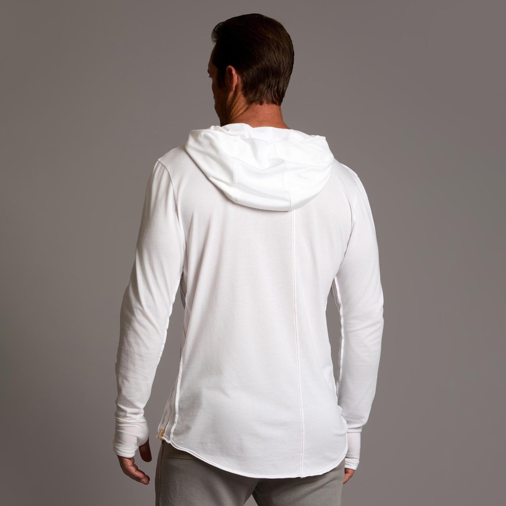 Man modeling white long-sleeve hooded tee