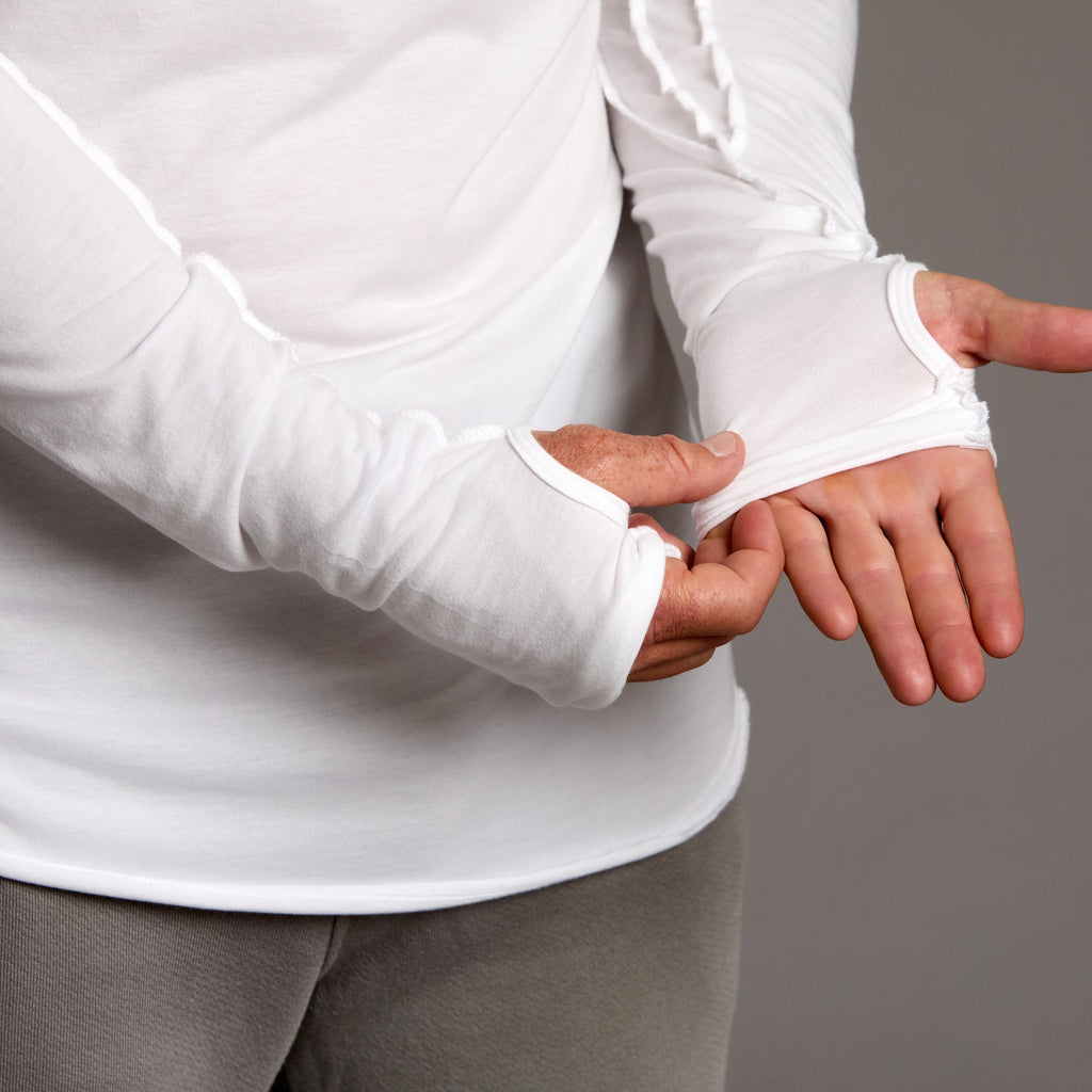 Man modeling white long-sleeve hooded tee