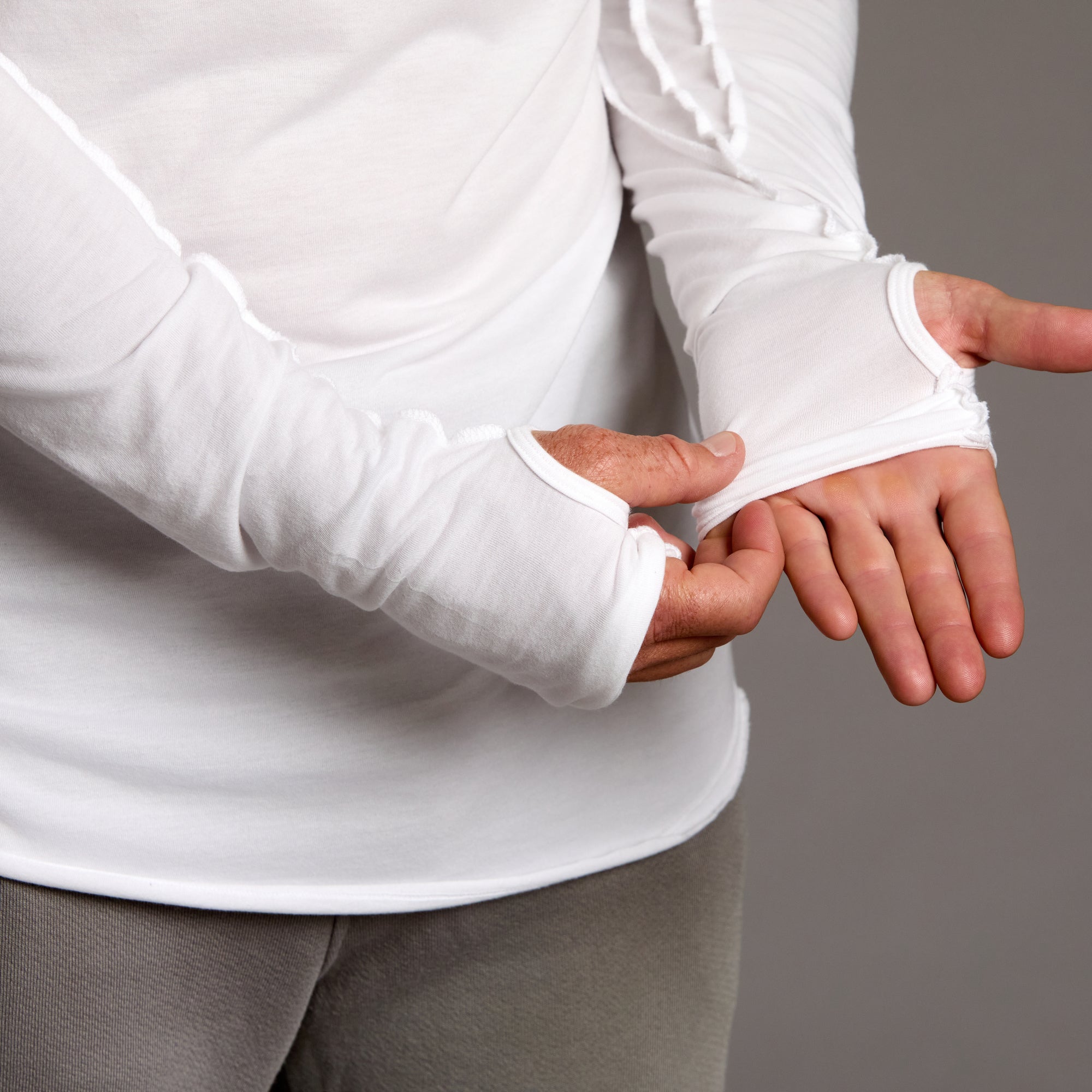 Man modeling white long-sleeve hooded tee