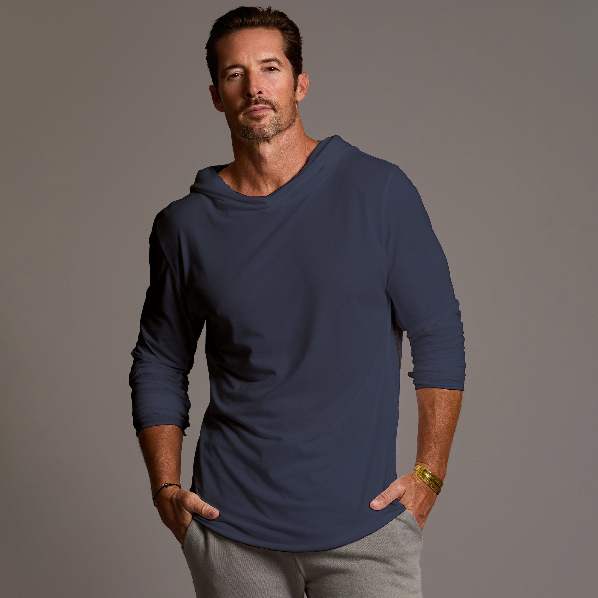 Man modeling blue long-sleeve hooded tee