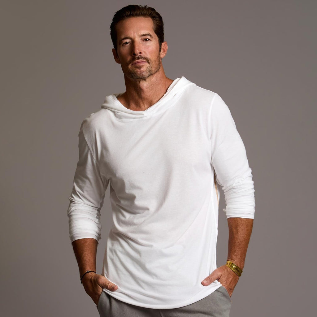 Man modeling white long-sleeve hooded tee
