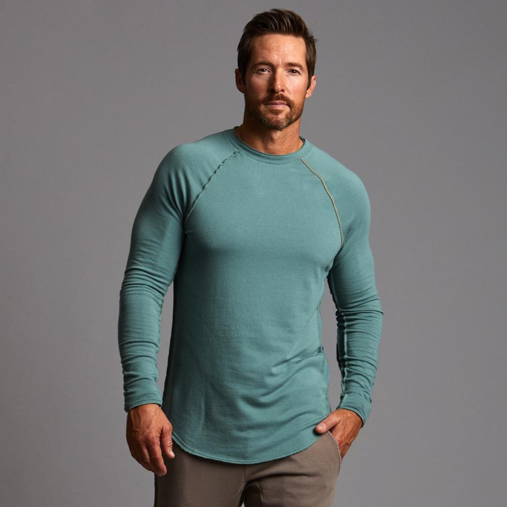 Male modeling teal long sleeve raglan