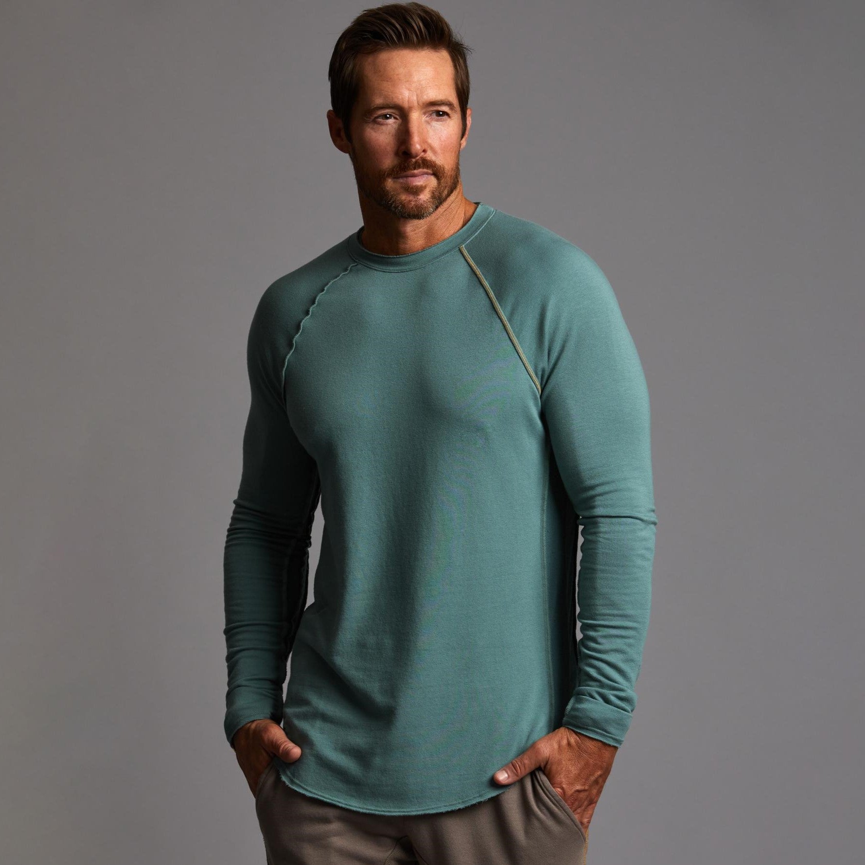 Male modeling teal long sleeve raglan